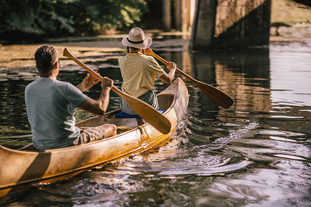 istock happy couple canoeing together on a paceful river at sunset 2224611806