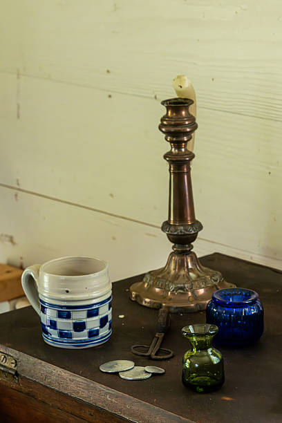 istock A brass candle holder, coffee cup and bowls on a table 2224612714