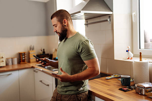 Man Managing Finances on Tablet and Smartphone