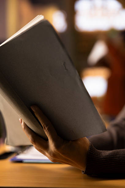 istock Woman sitting in a campus library study room to review academic materials 2224615016