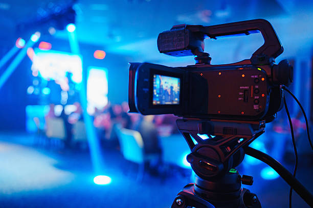 istock A professional videographer is filming a concert on stage. blurred stage. 2224615080