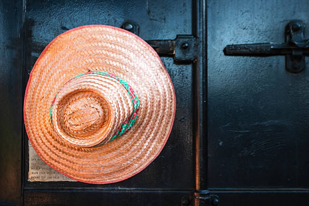 A woven hat hangs on the wall. Thai tradition hat.