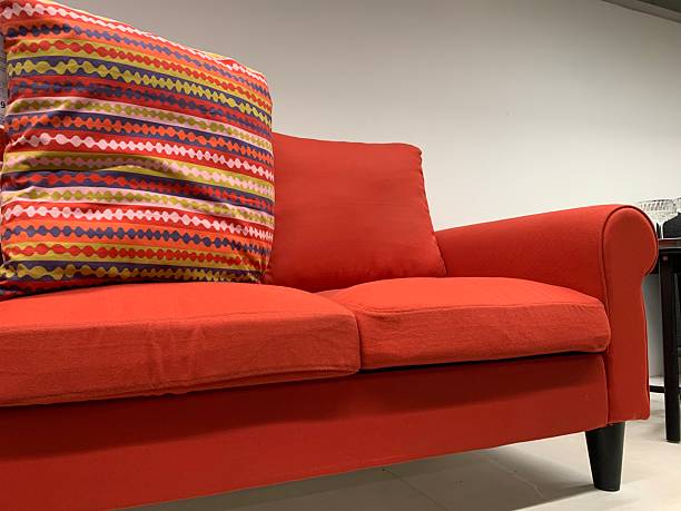 istock Bright Red Sofa with Colorful Geometric Pattern Pillow for Modern Interiors 2224615336