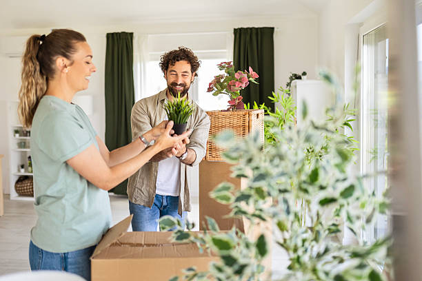 istock Happy Couple Unpacking Moving Boxes in Their New Home 2224615434