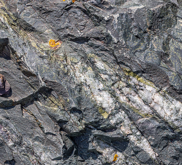 istock Rugged gray sedimentary rock formation with mineral veins 2224615814