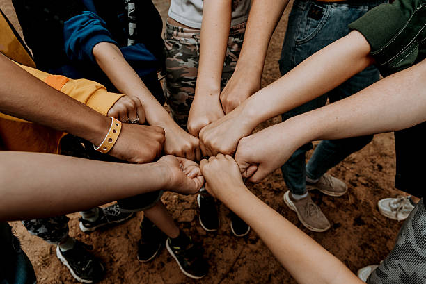 istock Group people banging fists in circle, team friend touch hands, teamwork together 2224615889