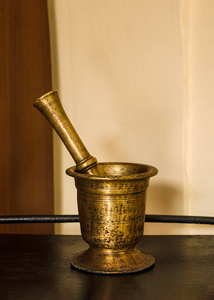 A copper mortar and pestle stands on the table