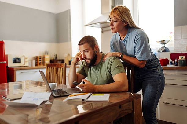 istock Concerned Man Reviewing Finances with Supportive Woman 2224616178