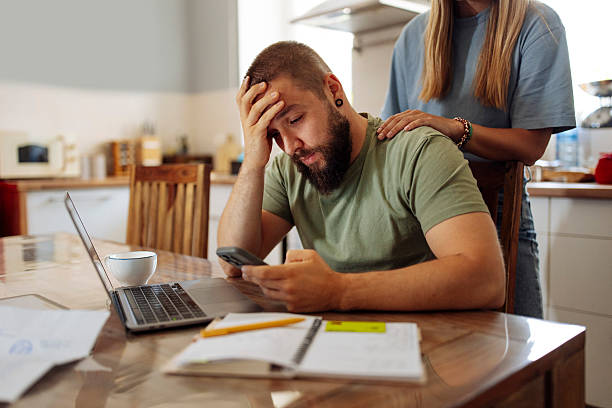 istock Stressed Man Managing Finances at Home 2224616214