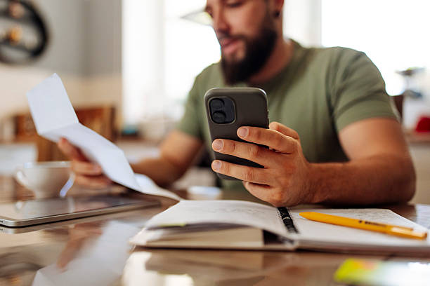 Man Reviewing Finances with Smartphone