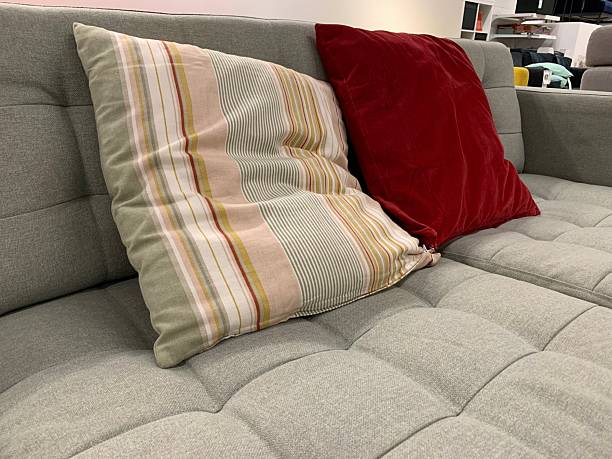 Modern Gray Sofa with Red and Striped Cushions – Cozy Interior Seating Photo