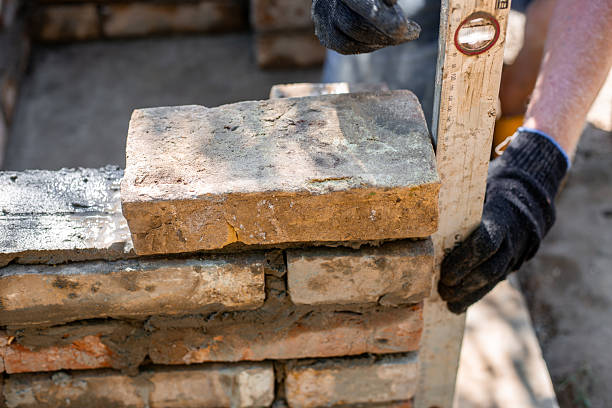 istock Close-up of leveling bricks during construction of brick structure using spirit level 2224616481