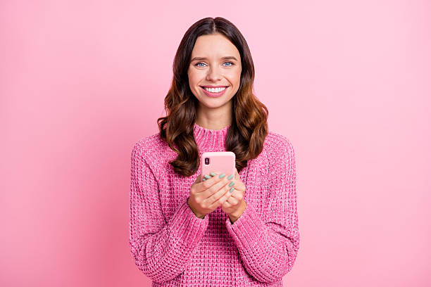 istock Portrait of attractive cheerful wavy-haired girl using device browsing web app smm isolated over pink pastel color background 2224616607