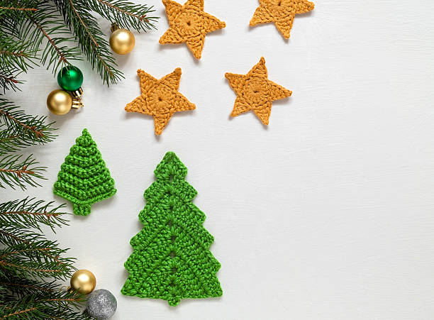 istock Festive Christmas composition on a white background. Handmade crochet green Christmas tree and yellow stars. Christmas craft ideas. Copy space. 2224616806