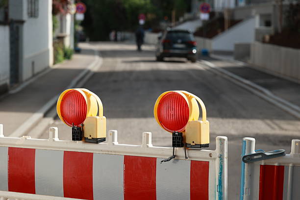 istock Red and white striped barrier with two red lights on top 2224619846