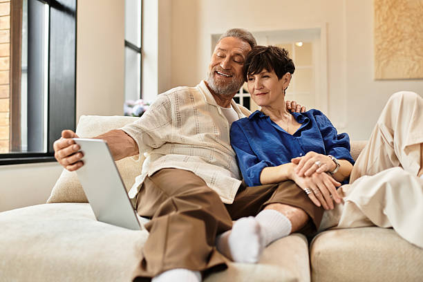 istock Middle aged couple enjoying quality time together at home while using a tablet 2224620256