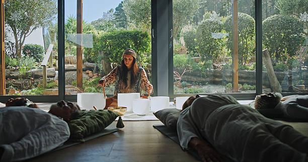 istock Woman, singing bowl and floor for holistic therapy, frequency and peace with mindfulness at studio. Group, shaman and healing with guide in class, crystal or zen for chakra balance at wellness resort 2224622969
