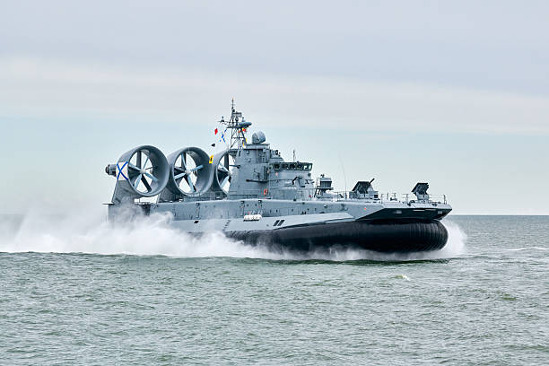 istock Hovercraft warship armed with armament sails into sea toward military target to attack and destroy 2224623998