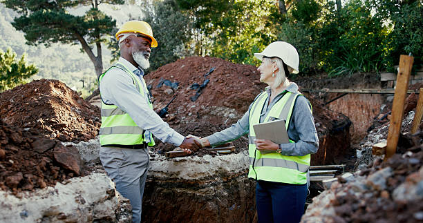 istock Construction site, contractor and people shaking hands for partnership outdoor for development. Man, woman or engineers together for excavation, agreement or collaboration with handshake or deal 2224624434