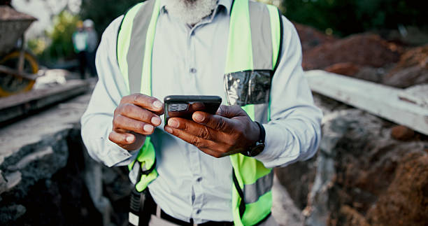 istock Construction site, hands and phone with person outdoor for communication, excavation or update. App, building and contact with professional developer typing on mobile for architecture or planning 2224624461