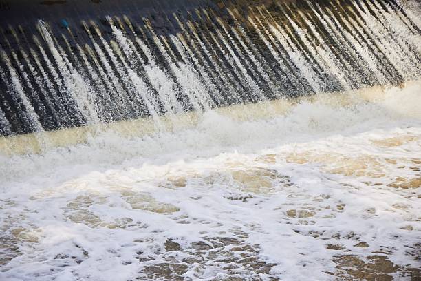 detailed texture of smooth flowing water at waterfall dam
