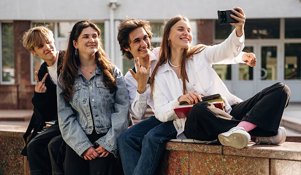 istock Making a selfie. Group of students are near university together 2224626619