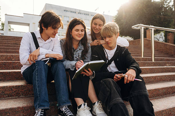 istock Interesting information, sitting and learning. Group of students are near university together 2224626811