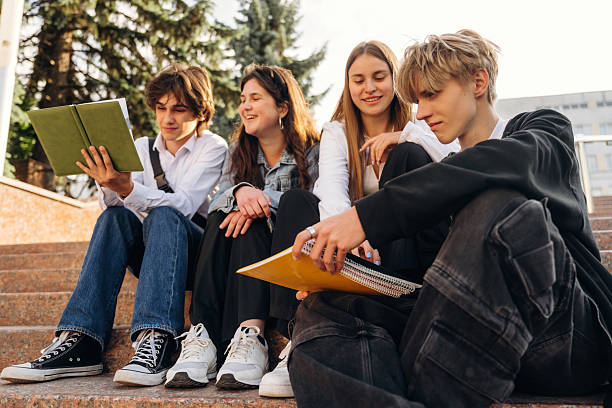 istock Interesting information, sitting and learning. Group of students are near university together 2224626858
