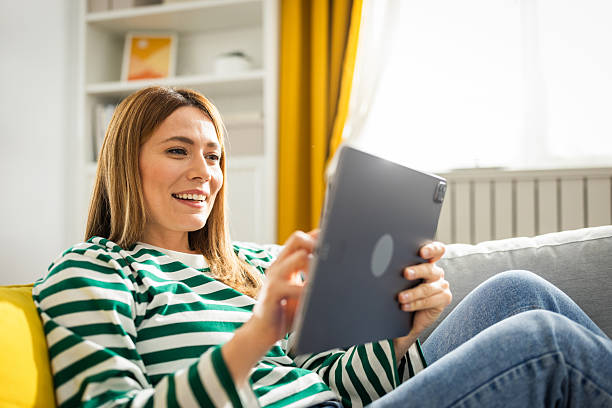 istock Young woman using digital tablet at home 2224628197