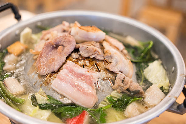 istock Sizzling hot Mookata, Thai BBQ grill pork on circle hot pan. 2224629026