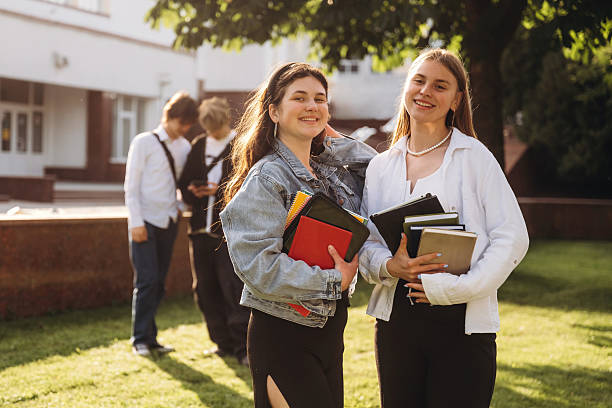 istock On the ground, lying down. Group of students are near university together 2224629849