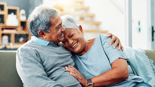 istock Smile, hug and senior couple in home, relax and commitment for relationship, bonding and love in lounge. House, old man and care for woman in living room, embrace and retirement for elderly people 2224629956