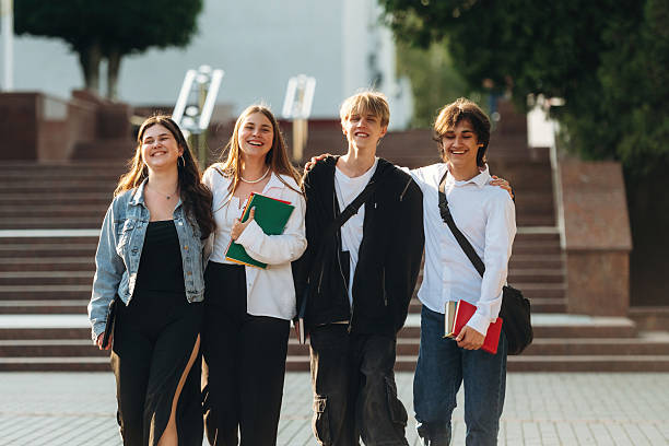 istock Having a break, walking. Group of students are near university together 2224630249