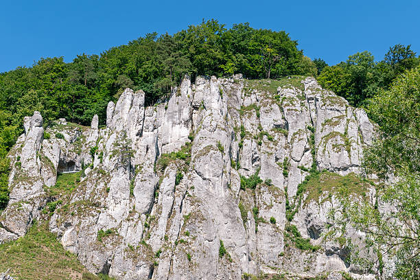 istock Majestic limestone cliffs with lush greenery under a clear blue sky 2224630910
