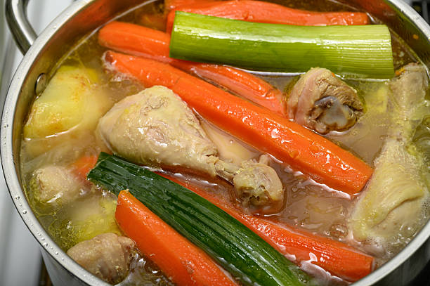 A classic vegetable and meat broth is cooked in a pot