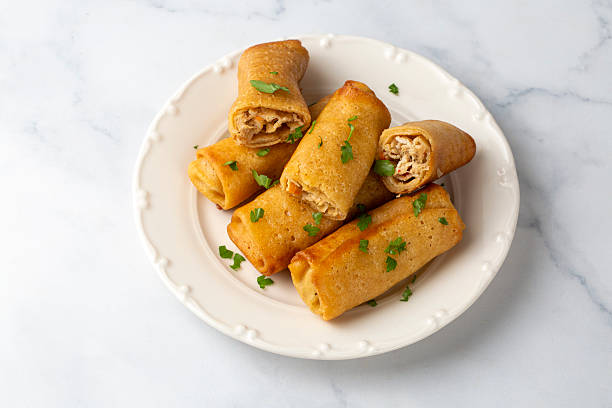 istock Pancakes or thin crepes stuffed with chicken and mushrooms on a plate 2224632238