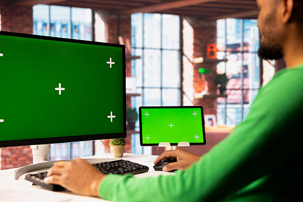 istock Man in living room using isolated screen PC and tablet 2224633558