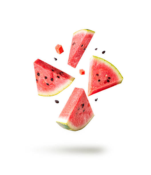 Watermelon pieces isolated with ceeds flying isolated on white. Falling slices set. Red berry splash.