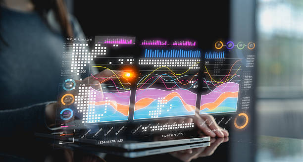 istock A person interacts with a tablet using a stylus, displaying futuristic digital charts and graphs floating above the device. 2224635108