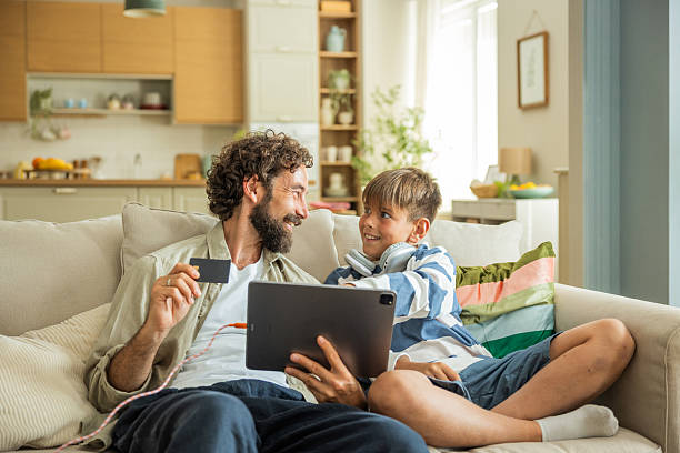 Father and son shopping online at home