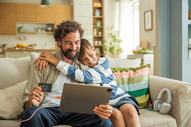 Father and son shopping online at home