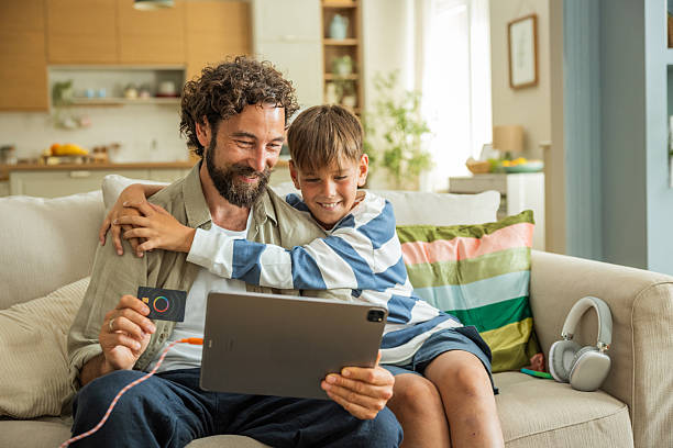istock Father and son shopping online at home 2224635669