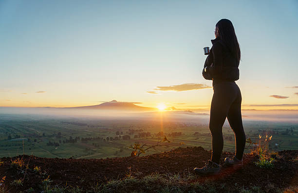 istock Hiker watching the sunrise over the valley from the mountain top 2224640209