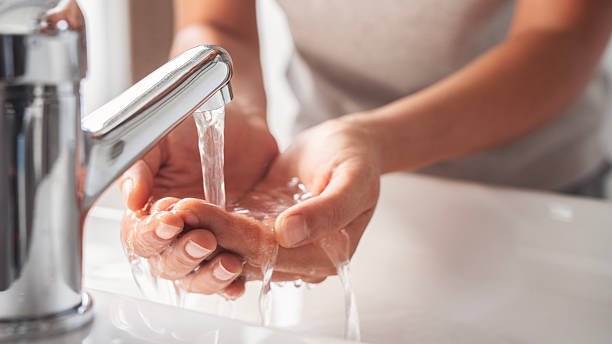 istock Woman washing her hands in the bathroom 2224641377