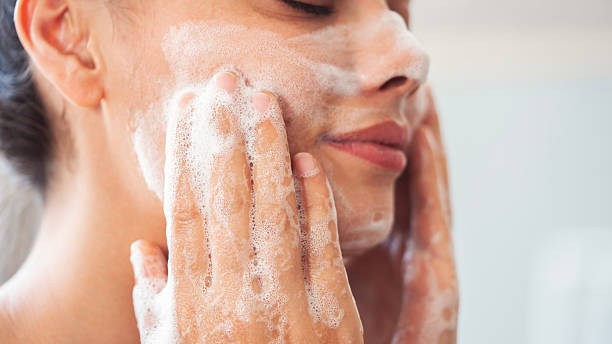 istock Beautiful woman washing her face 2224641472