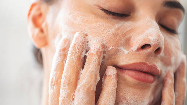 istock Beautiful woman washing her face 2224641473