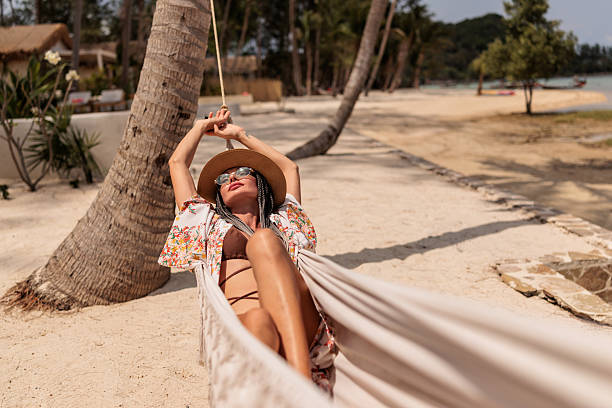 istock Woman in hammock on the sandy beach 2224644838