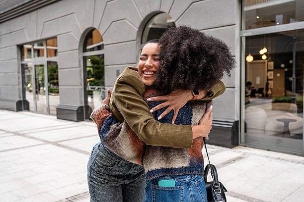 istock Two young women embracing in the city 2224645012