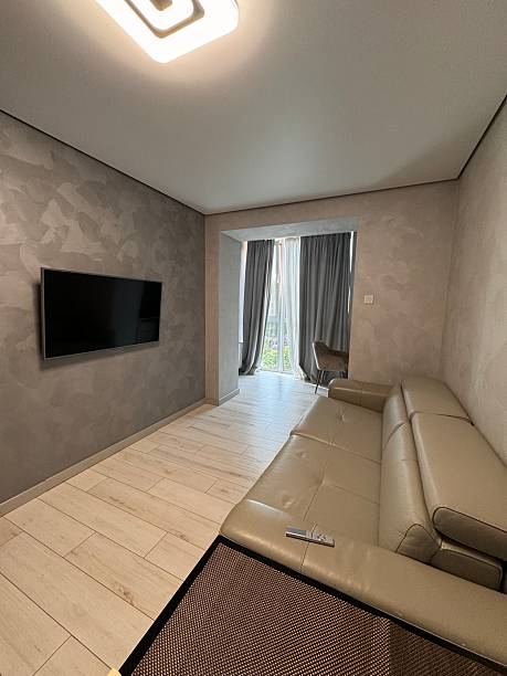 istock Minimalist Living Room with Modern Sofa and Wall-Mounted TV 2224645316