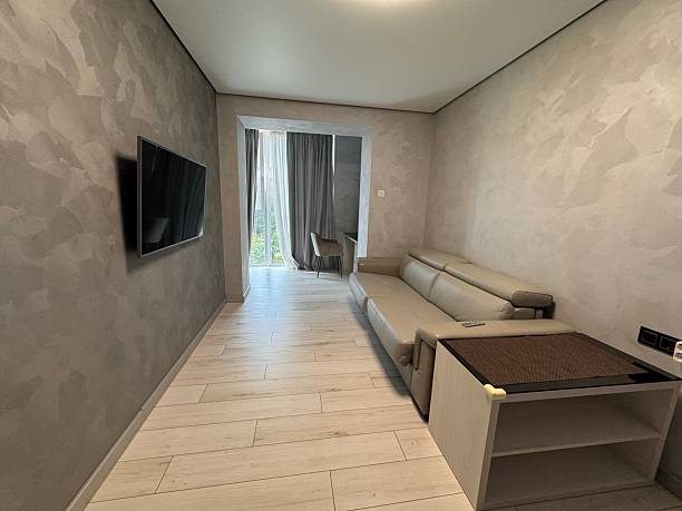istock Minimalist Living Room with Modern Sofa and Wall-Mounted TV 2224645321